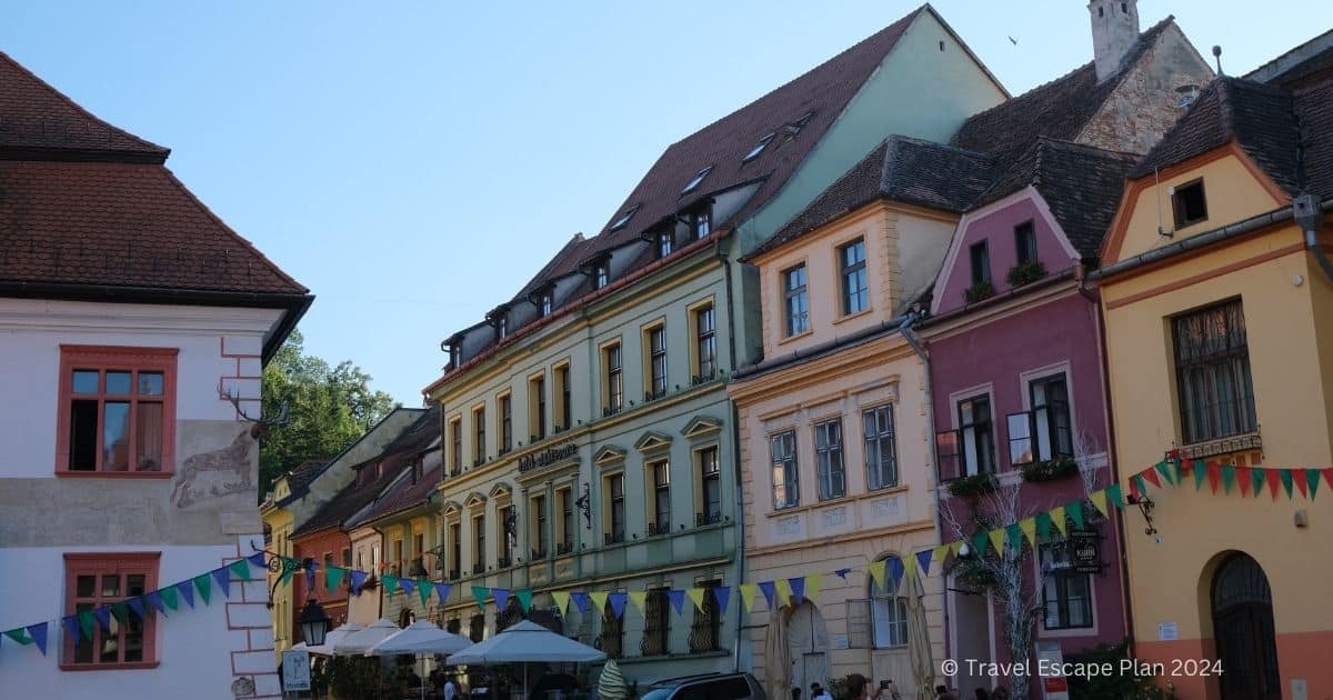 colourful pastel buildings in the main square of medieval city Sighisoara in Romania