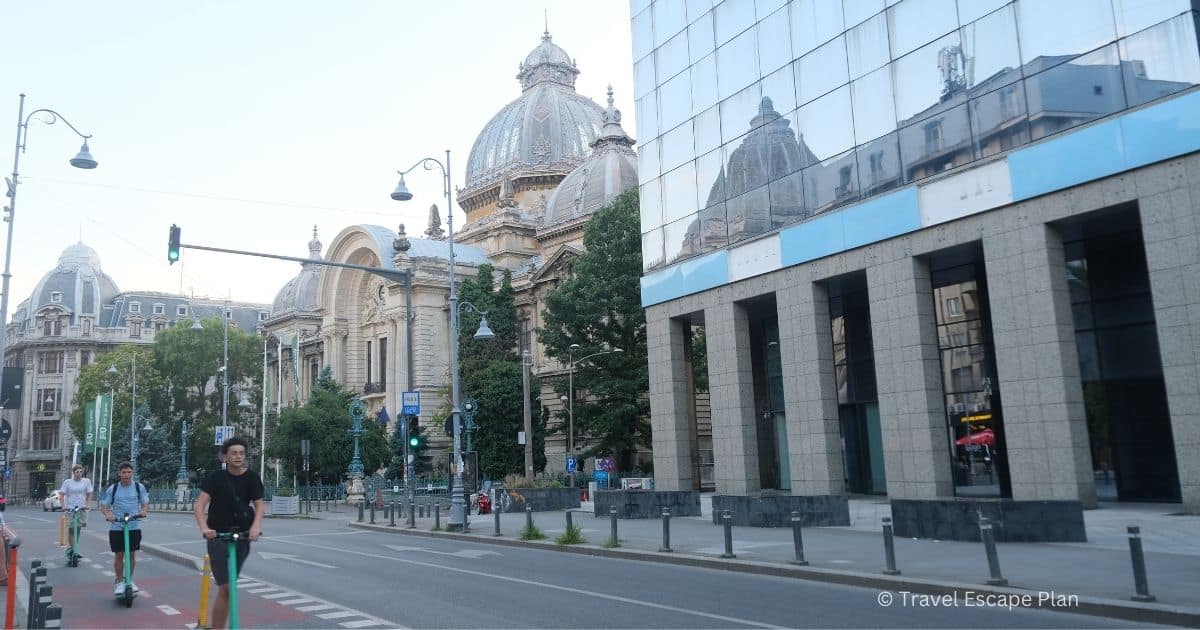 pedestrians on riding along Victory Ave on a scooter in Bucharest