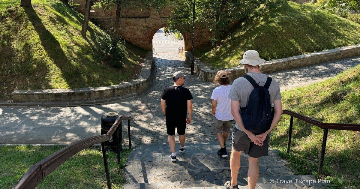 a couple of tourists following a walking tour guide down the stairs
