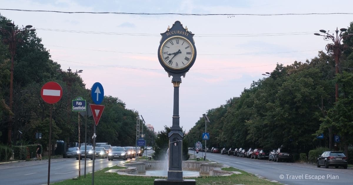 Street view of Bucharest clock in the middle of Boulevard Unirii