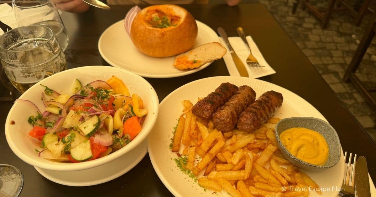 mici sausages, ciorba soup and salad lunch meal at Caru cu Bere restaurant, Old Town Bucharest