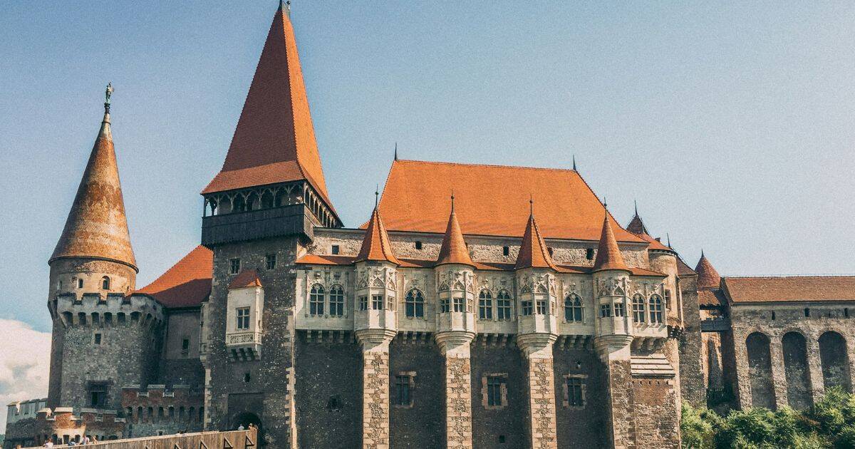 Corvin Castle in Romania with it's pointy towers and drawbridge gate